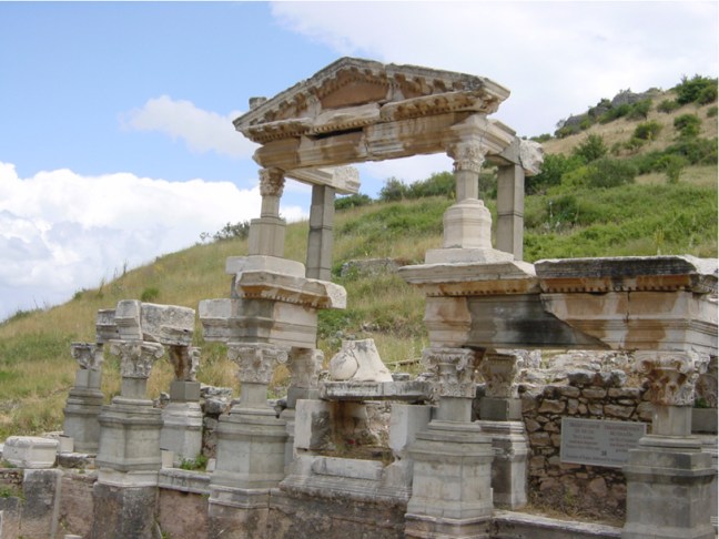 This Ephesian monument is known as the Fountain of Trajan (Nymphaeum Traiani) and was dedicated to this emperor no later than AD 114. The center niche originally contained a colossal statue of the emperor Trajan. The fragmentary remains include the foot of the Emperor Trajan next to a globe representing a subservient earth. Page 39, figure 27.